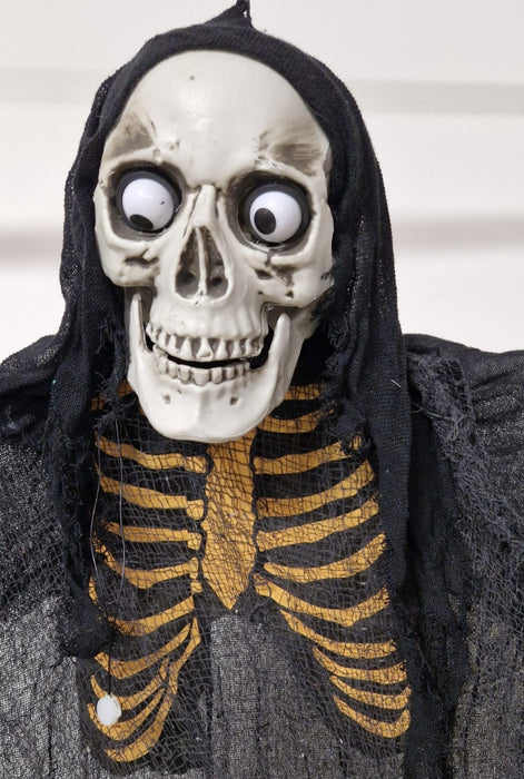 SCHELETRO SONORO CON TUNICA NERA E OCCHI LUMINOSI E GIREVOLI