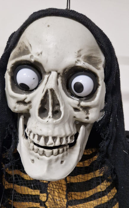 SCHELETRO SONORO CON TUNICA NERA E OCCHI LUMINOSI E GIREVOLI